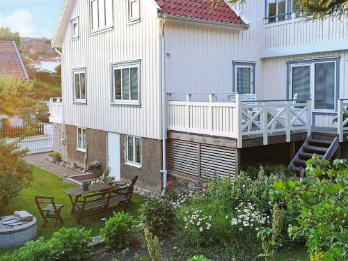 a house with a patio and a table in the yard at 4 person holiday home in Sk rhamn in Skärhamn