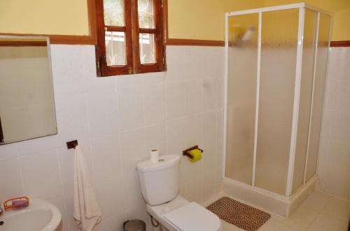 uma casa de banho com um chuveiro, um WC e um lavatório. em Casa modelo Colonial - Guest House Quinta Natural em Graça