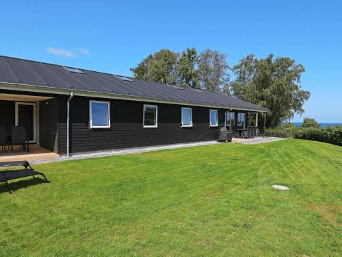a house with a large yard in front of it at 16 person holiday home in Alling bro in Rygård Strand