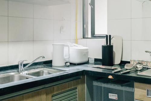 a kitchen with a sink and a counter top at [Roader] Wuhan Jiang'an District, Hong Kong Road in Wuhan