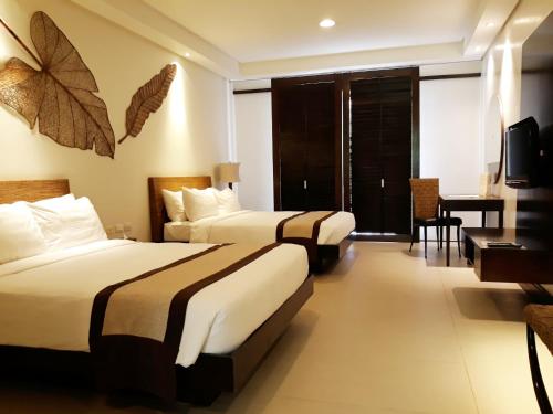 เตียงในห้องที่ Kamana Sanctuary Resort & Spa