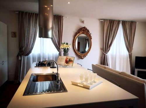 a kitchen counter with a sink and a mirror at Casa Carla, immersa nel verde dei colli Bolognesi in Sasso Marconi