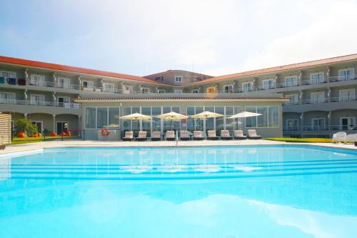 a large swimming pool in front of a hotel at Star inn Peniche in Peniche