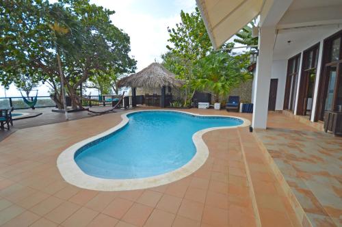a swimming pool in the middle of a house at Villas Sur Mer in Negril