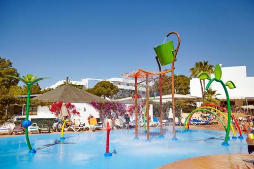 a swimming pool with a bunch of colorful water structures at Hotel Club Es Talaial in Cala d´Or