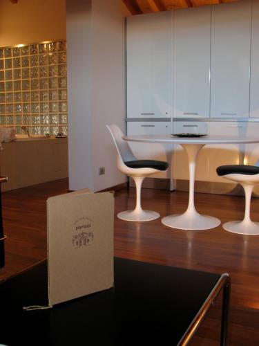 a box sitting on the floor next to a table and chairs at Parizzi Suites & Restaurant in Parma