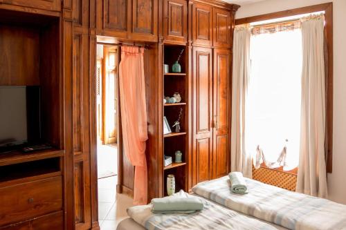 a bedroom with two beds and a book shelf at 8 Small and cozy Suite in Timişoara