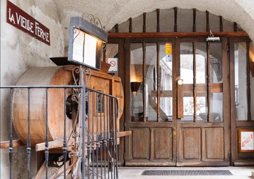 an entrance to a wine tasting room with a wooden door at Langley Hotel La Vieille Ferme in La Salle Les Alpes