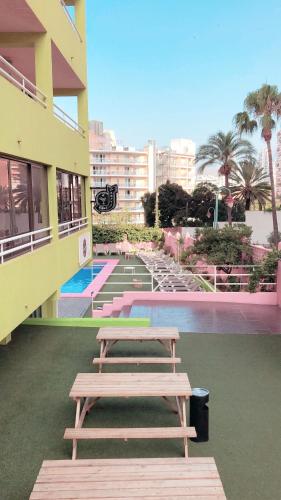 two picnic tables on the side of a building at Now Benidorm in Benidorm