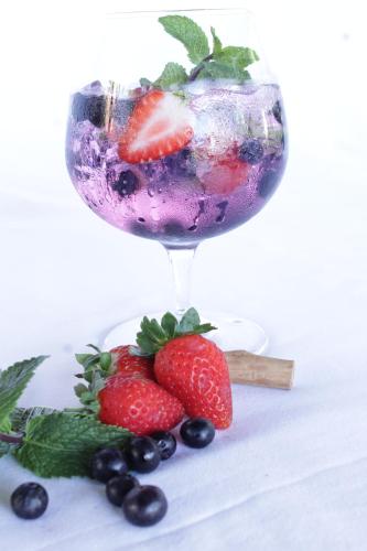 a drink in a glass with strawberries and blueberries at iLanga Lodge in St Lucia