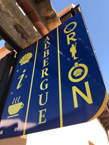 a blue and white sign for a restaurant at Albergue Orion in Castrojeriz