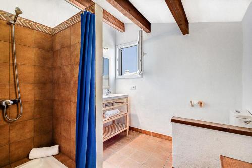 a bathroom with a shower and a sink at Villa FARO by Mauter Villas in Cala en Bosc