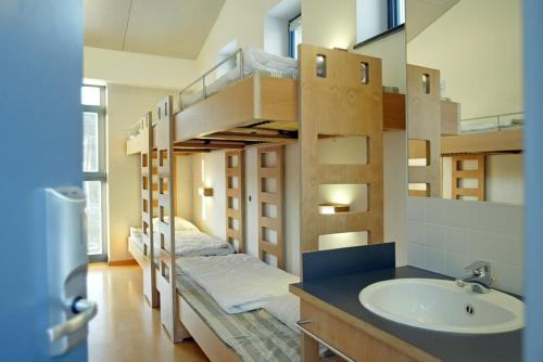 un bagno con un letto a castello, un lavandino e un lavandino di Youth Hostel Lultzhausen a Lultzhausen