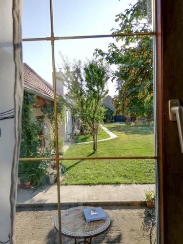 a window view of a garden outside a house at Anna's Cosy Apartment in Illmitz