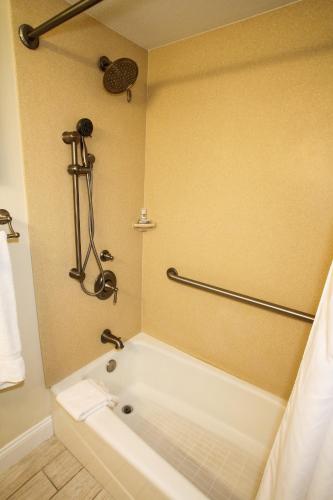 a bath tub in a bathroom with a shower at Ocean Club on Smuggler's Beach in South Yarmouth