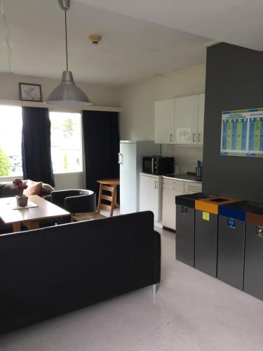 a kitchen and living room with a couch and a table at Molde Vandrerhjem Hostel in Molde