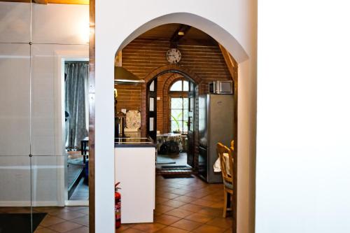a kitchen with an archway leading into a living room at Spacious Klaipeda Apartment EV in Klaipėda