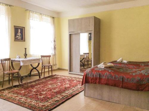 a bedroom with a bed and a table and a mirror at Icho House in Stepantsminda