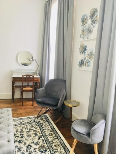 a living room with two chairs and a table at Manoir 1838 à - 3 km du Zoo de Beauval & proche des châteaux in Saint-Aignan