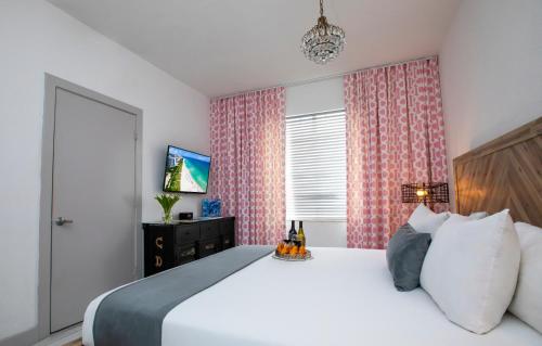 
a bedroom with a bed and a television at Whitelaw Hotel in Miami Beach

