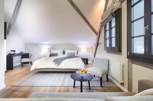 a bedroom with a bed and a living room at La Ferme du Château in Lucens