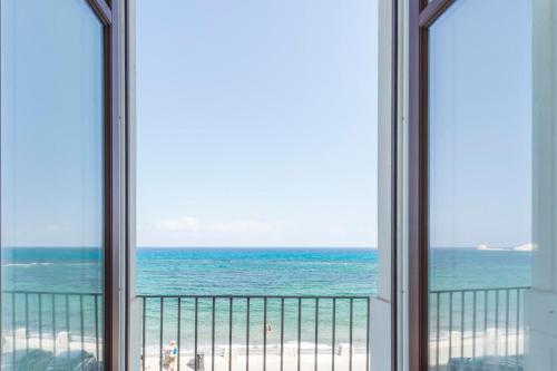 a view of the ocean from a balcony at Central Gallery Rooms- Palazzo D'Ali' Staiti XIX in Trapani