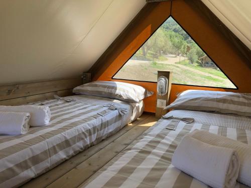 Postel nebo postele na pokoji v ubytování Glamping Tuscany - Podere Cortesi