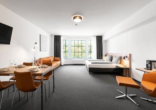 a living room with a couch and a table at Apartimo Landshut in Landshut