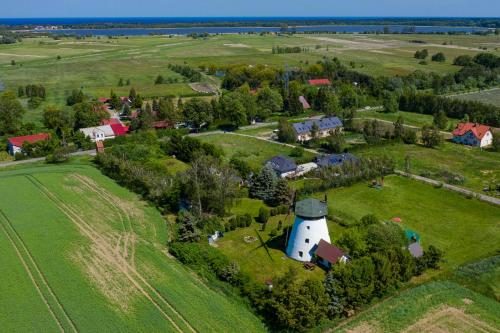 an aerial view of a farm with a white tower at Windmill vacation home in Ledzin near Baltic Sea in Niechorze