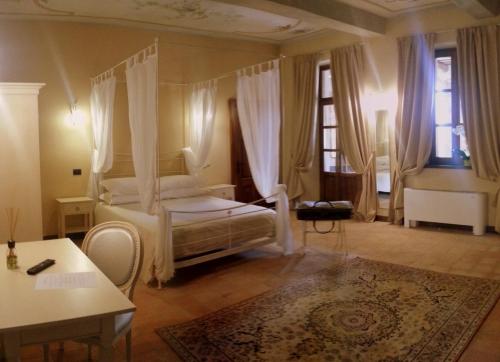 a bedroom with a bed with a canopy at Dimora Cortese in Castagnole Lanze