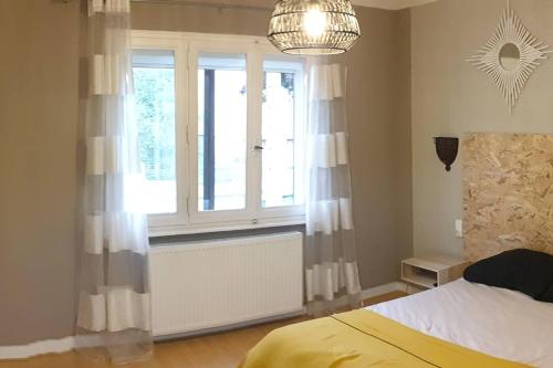 a bedroom with a bed and a window with a radiator at Mieux que Chez Soi in Metz