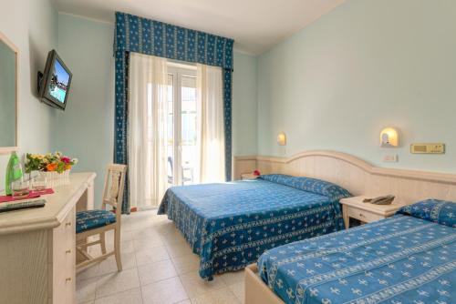 Postel nebo postele na pokoji v ubytování Hotel Splendid Mare