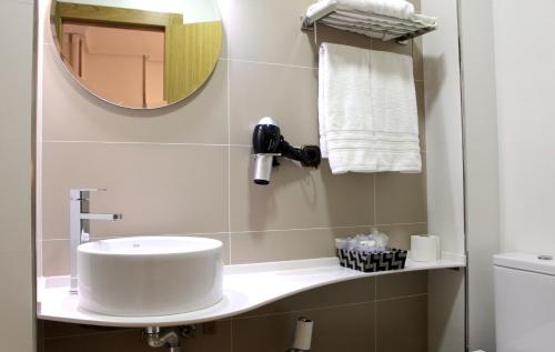 a bathroom with a sink and a mirror at Hotel Restaurante Santos in Santomera