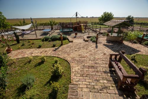 a brick patio with a park with a playground at Provence Birtok in Decs