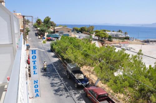 a street with cars parked on the side of a beach at Nora Hotel in Sitia
