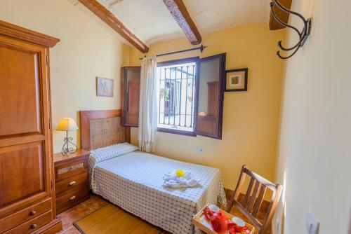 a small bedroom with a bed and a window at Casa Rural Rivero in Posadas