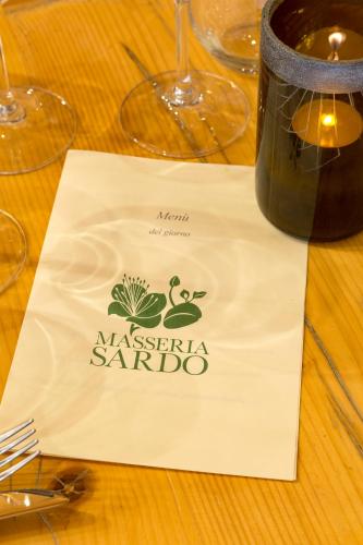 a napkin on a table with a wine glass at Masseria Sardo in Pozzuoli