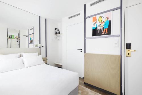 a hotel room with a bed and a television at French Theory in Paris