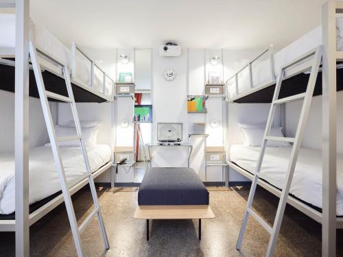 Ce dortoir comprend deux lits superposés et un bureau. dans l'établissement French Theory, à Paris
