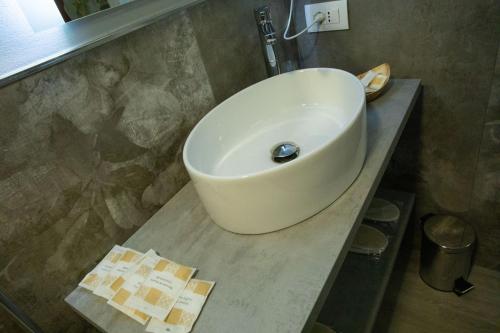 a white sink sitting on a counter in a bathroom at AL 54 Accommodation in San Benedetto del Tronto