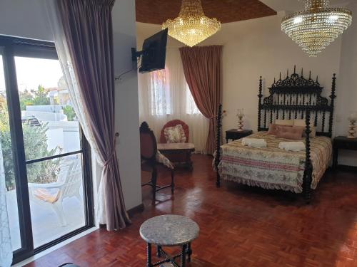 a bedroom with a bed and a chandelier at OceanOasis Residences Suites in Olhão