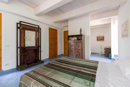 a bedroom with a large bed and a dresser at Masseria Sardo in Pozzuoli