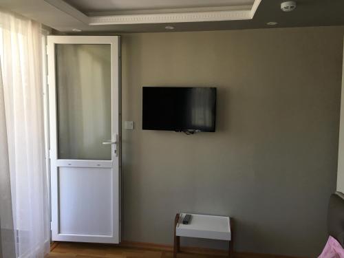 a flat screen tv on a wall next to a door at PASHA APART~BOUTİQUE HOTEL/YALOVA in Yalova