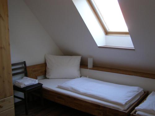 a bed in a room with a window at Hotel Alt Vinnhorst in Hannover