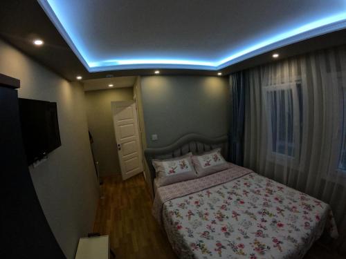 a bedroom with a bed and a blue light at PASHA APART~BOUTİQUE HOTEL/YALOVA in Yalova