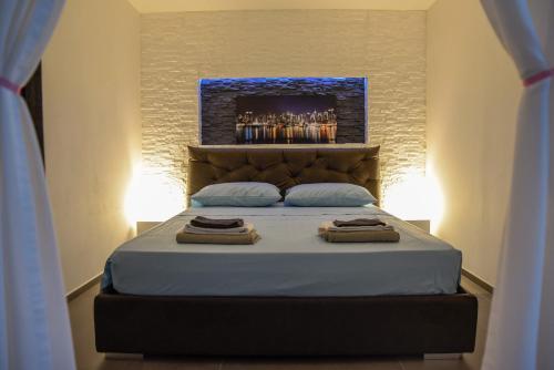 a bedroom with a bed with two towels on it at Kalendoola's Suite in Lecce