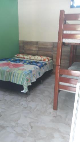 a bedroom with a bunk bed and a ladder at Pousada Casa Branca in Salinópolis