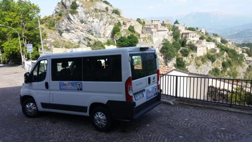 a small white van parked on the side of a hill at Appartamento Vacanza in Torre deʼ Passeri