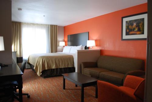 um quarto de hotel com uma cama e um sofá em Quality Inn & Suites Fresno Northwest em Fresno