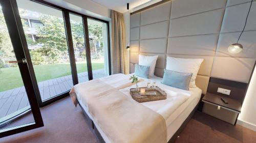 ein Schlafzimmer mit einem großen Bett und einem Korb darauf in der Unterkunft White Pearl Appartment 0.16 in Timmendorfer Strand